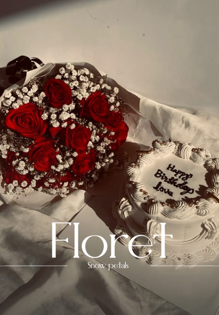 Snowfall bouquet — Velvet red roses dusted in baby's breath, beside a love-lettered birthday cake